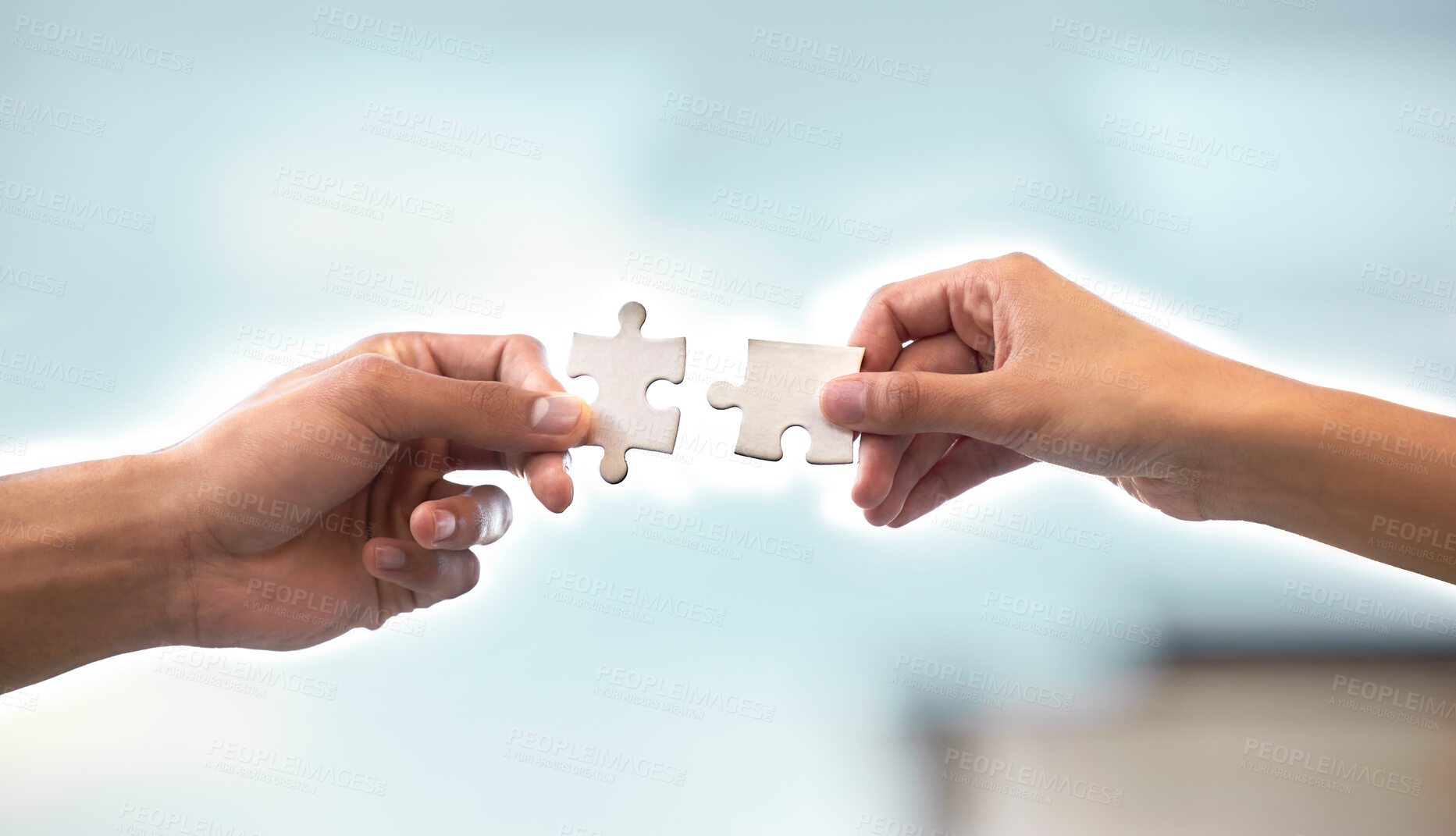 Buy stock photo Cropped shot of two unrecognizable businesspeople holding up two puzzle pieces in the office