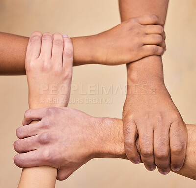 Buy stock photo High angle shot of a diverse group of businesspeople holding each other's wrists in the office
