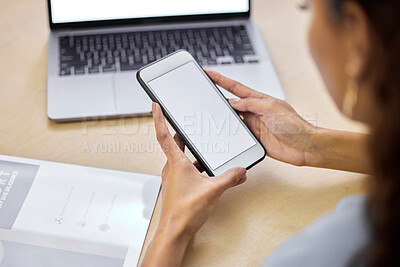 Buy stock photo Cropped shot of an unrecognizable businesswoman sitting alone in the office and using her cellphone