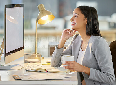 Buy stock photo Shot of a young businesswoman using a computer and having coffee in a modern office