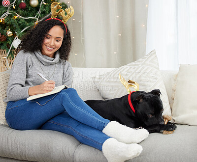 Buy stock photo Dog, Christmas and home with woman, notebook and celebration in lounge or living room. Pet, festive holiday and comfort for cute, best friend and animal bonding with reindeer costume for vacation fun