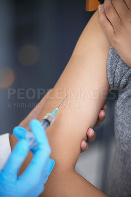 Buy stock photo Shot of a woman receiving an injection at a Covid-19 vaccination centre