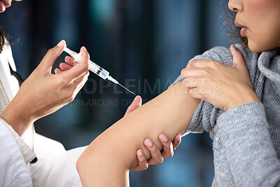 Buy stock photo Shot of a woman receiving an injection at a Covid-19 vaccination centre