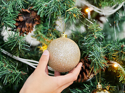 Buy stock photo Person, hands and ball with Christmas tree for decoration, festive or holiday season at home. Closeup of ornament, lights and decor with glitter bauble in December celebration or new year preparation