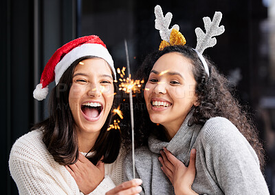 Buy stock photo Women friends, Christmas and sparkle light with smile, home and celebration of festive holiday. Girl, woman and excited with fireworks, celebrate and happiness on vacation, laughing and xmas bonding