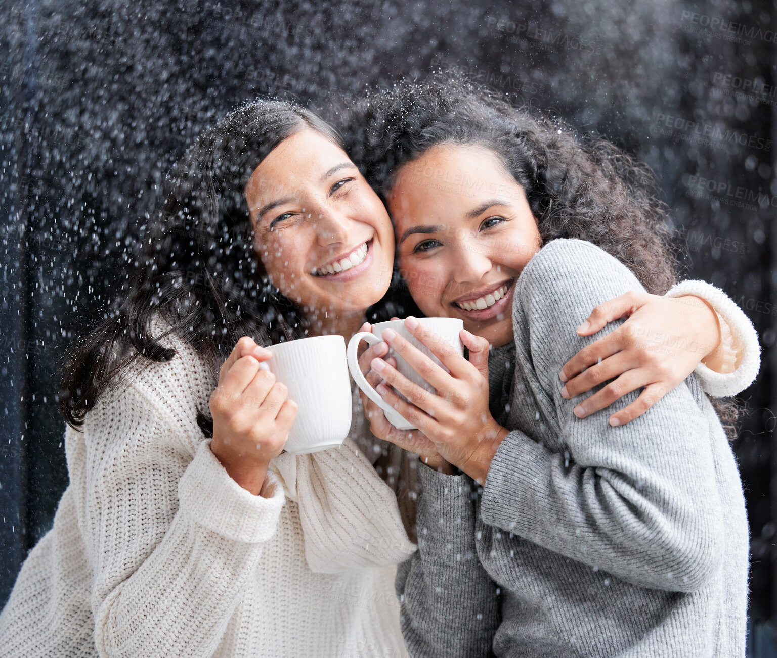 Buy stock photo Shot of two young women drinking coffee in the snow outside