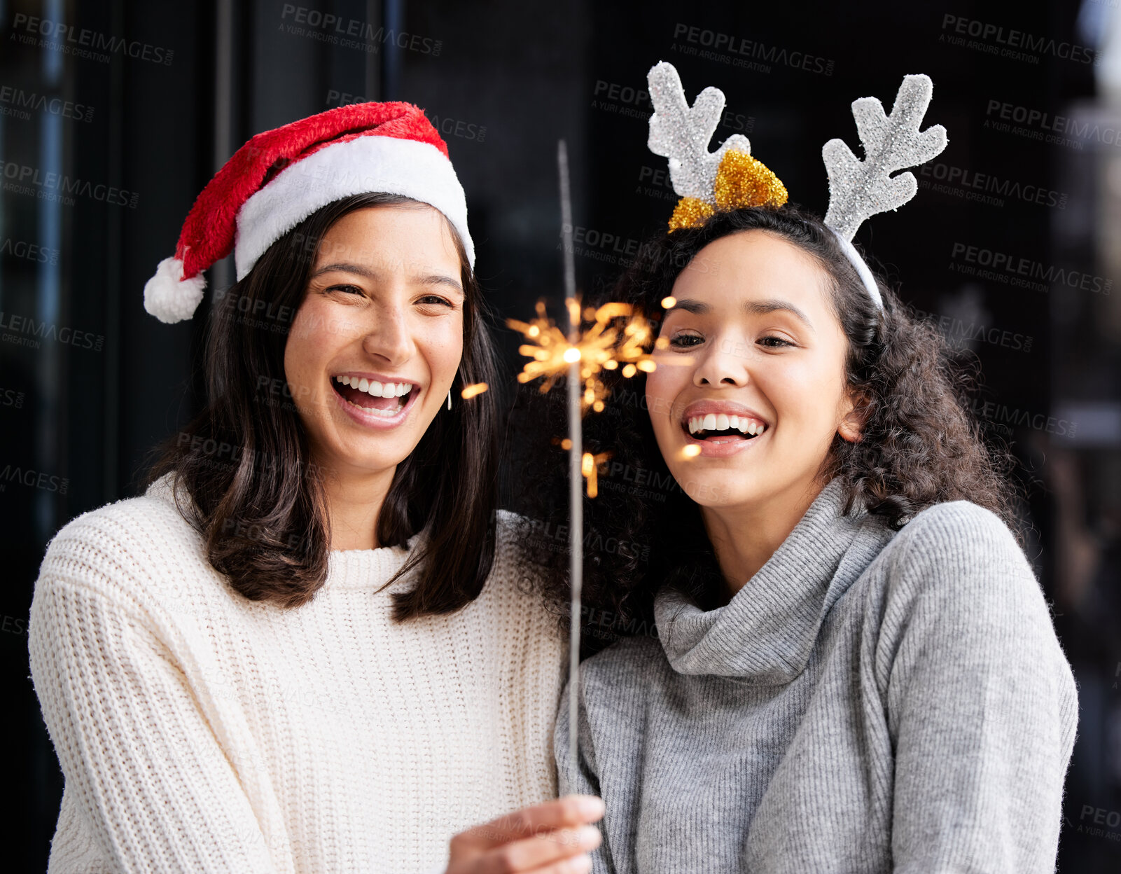 Buy stock photo Women friends, Christmas and sparkle stick with smile, home and celebration of festive holiday. Girl, woman and fireworks with light to celebrate for happiness, vacation or laughing with xmas bonding