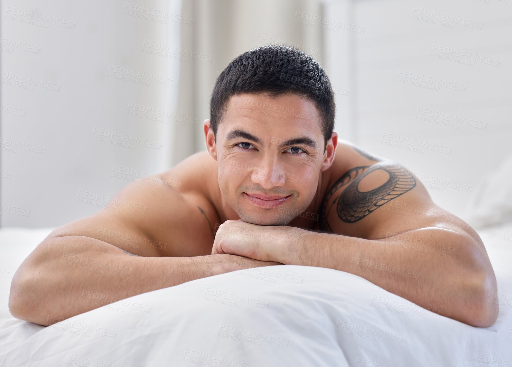 Buy stock photo Bedroom, portrait and man with smile, shirtless and relax on bed, happy and thinking in morning. Home, muscle and fitness of body and person in apartment, confidence and tattoo on arm in house