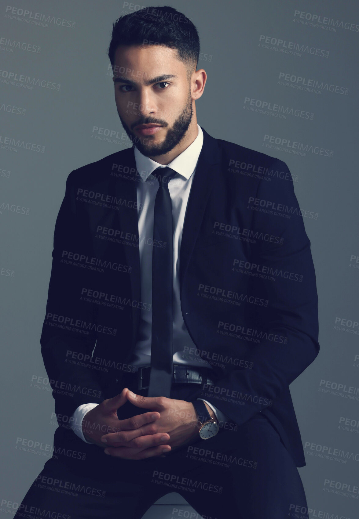 Buy stock photo Studio shot of a young man posing against a grey background