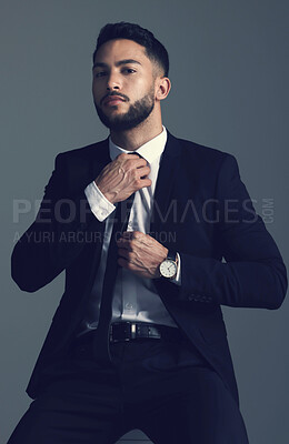 Buy stock photo Confident businessman, portrait and fashion with suit in formal attire or clothing on a dark studio background. Handsome man, young employee or model with stylish outfit, tie and ready for business