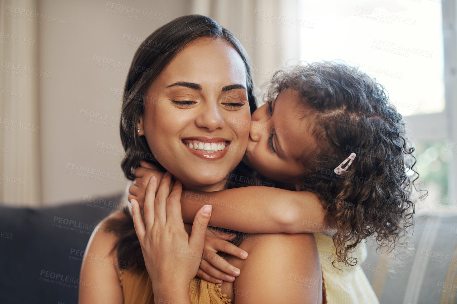 Buy stock photo Mom, daughter and hug with kiss on sofa for bonding with love, affection and childhood security for support. Mother, girl and relax with care in living room of home, together and nurture connection.