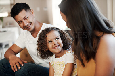 Buy stock photo Shot of a happy couple sitting on the sofa and bonding with their daughter at home