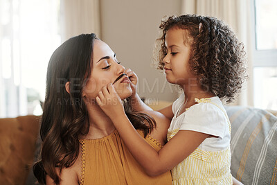 Buy stock photo Shot of an adorable young girl feeling playful while bonding with her mother at home
