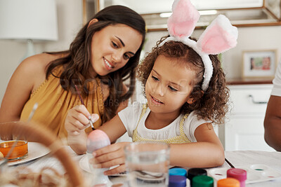 Buy stock photo Shot of a mother painting easter eggs with her daughter