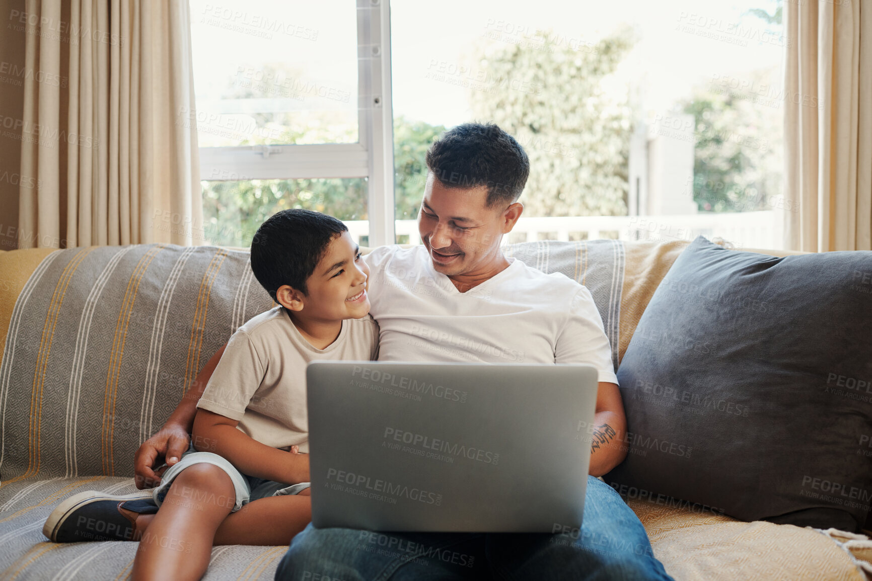 Buy stock photo Father, boy and hug with laptop on sofa for streaming cartoon movies, entertainment videos and bonding. Dad, child and relax in living room of home with technology for online gaming and happiness.