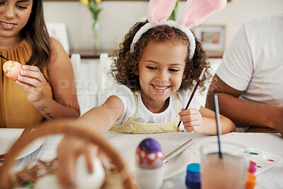 Buy stock photo Shot of a family painting Easter eggs together