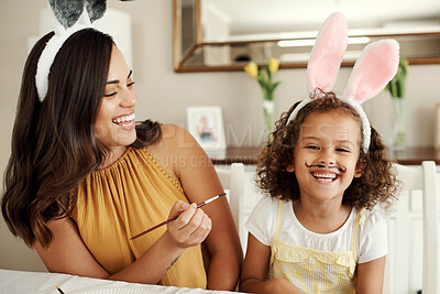 Buy stock photo Shot of a beautiful young woman painting her daughters face
