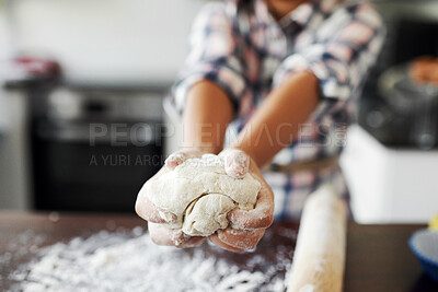 Buy stock photo Cropped shot of an unrecognizable girl having fun while baking in the kitchen at home