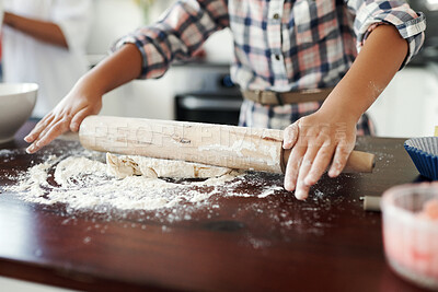 Buy stock photo Cropped shot of an unrecognizable girl having fun while baking in the kitchen at home
