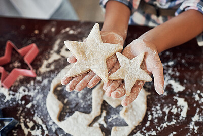 Buy stock photo Cropped shot of an unrecognizable girl making star shaped cookies in the kitchen at home