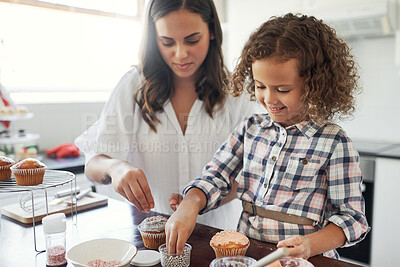 Buy stock photo Shot of an adorable little girl baking with her mom at home