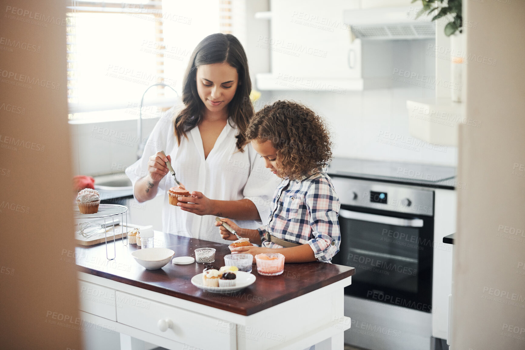 Buy stock photo Shot of an adorable little girl baking with her mom at home