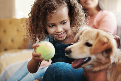 Buy stock photo Shot of an adorable young girl playing with her dog in the living room at home