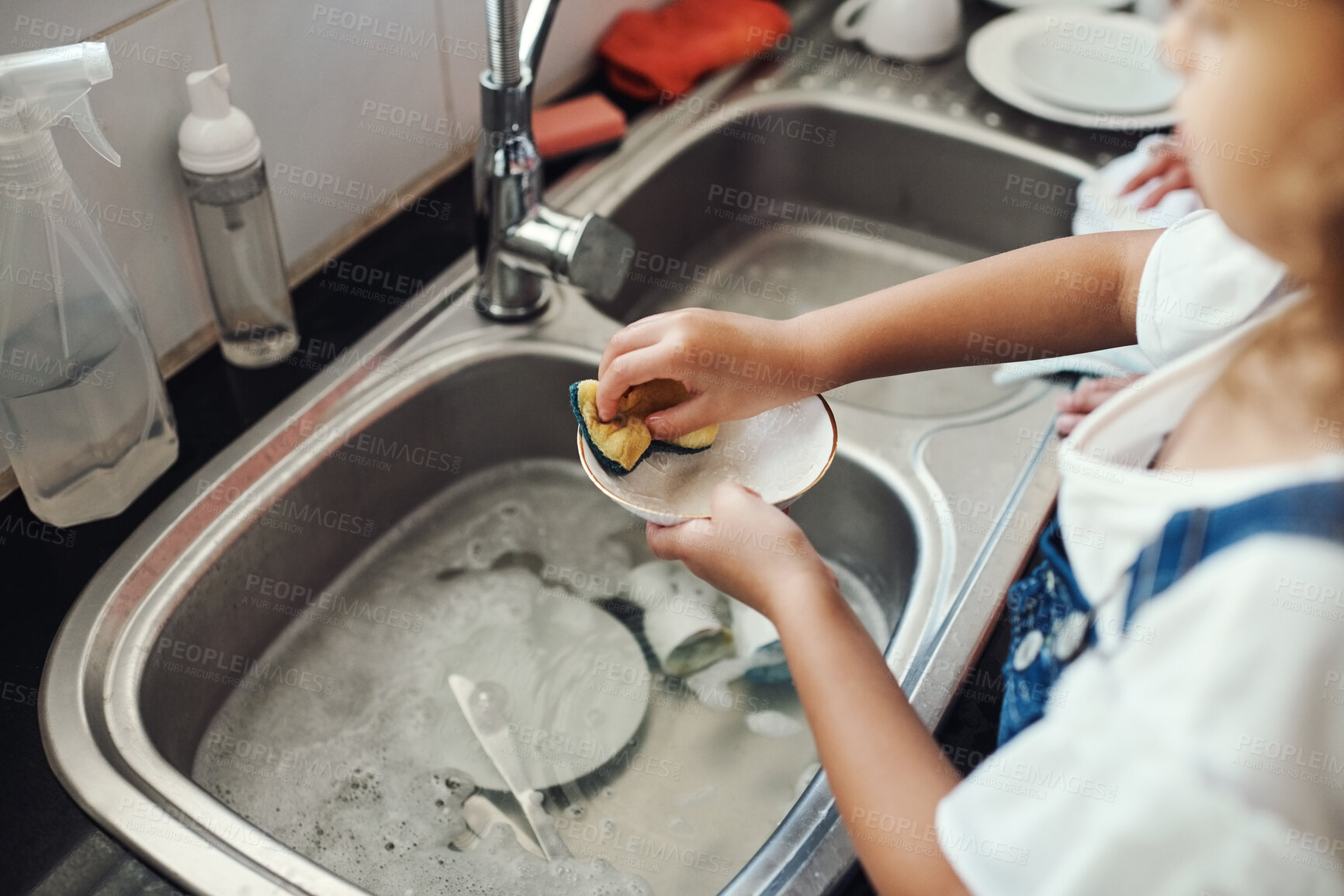 Buy stock photo Girl, water and learning to wash dishes in kitchen, sanitary and prevent bacteria or germs. Female person, child and soap for cleaning mess in home, housework and kid helping for responsibility