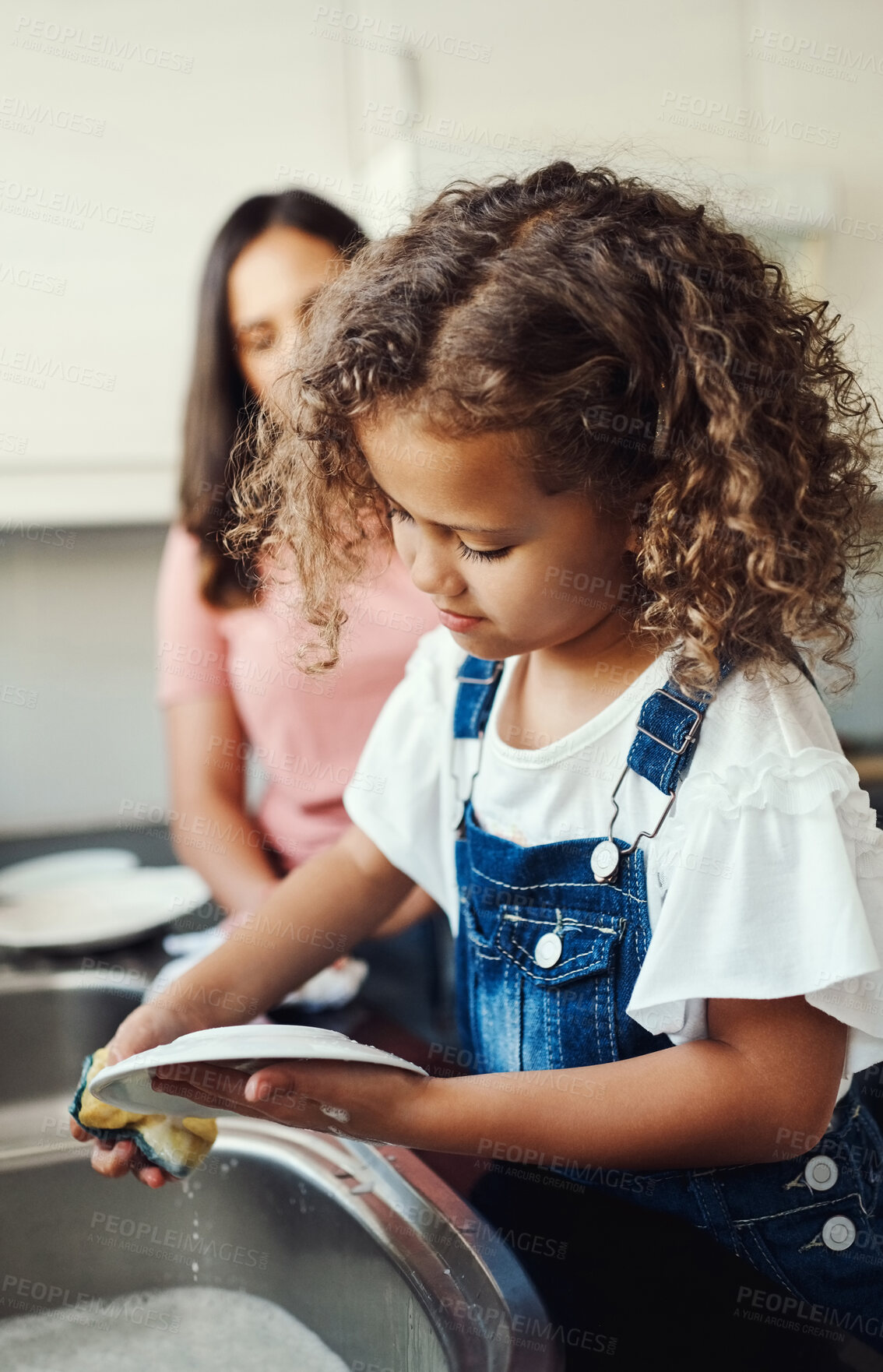 Buy stock photo Girl, helping mother and washing dishes in kitchen, sanitary and prevent bacteria or germs. Female person, child and soap for cleaning plates in home, housework and kid for learning responsibility