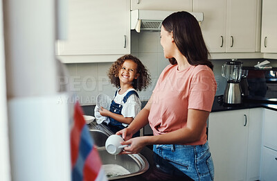 Buy stock photo Mother, girl and teaching to wash dishes in kitchen, hygiene and talking in home for cleaning. Mommy, daughter and family for household chores to remove dirt, learning responsibility and teamwork