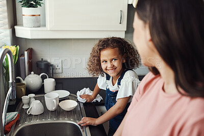 Buy stock photo Mother, girl and dry dishes for housework in kitchen, hygiene and talking in home for cleaning. Mommy, daughter and family for chores to remove dirt, learning responsibility and teamwork bonding