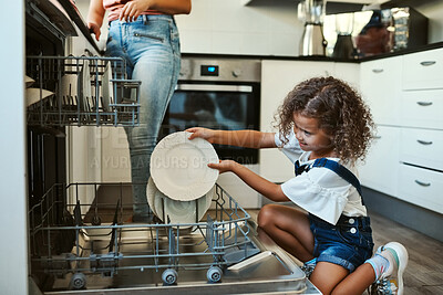 Buy stock photo Shot of an adorable young girl helping her mother with the dishes in the kitchen at home