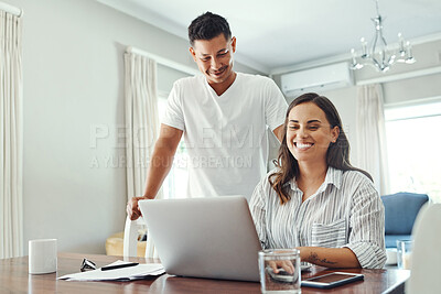 Buy stock photo Cropped shot of a young couple using a laptop to their household budget in the living room at home