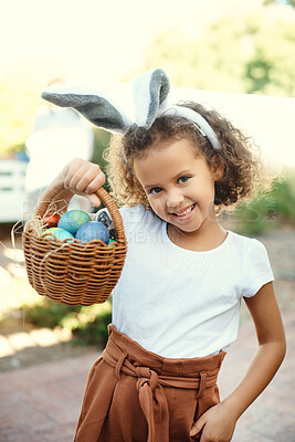 Buy stock photo Shot of a girl carrying a basket of easter eggs