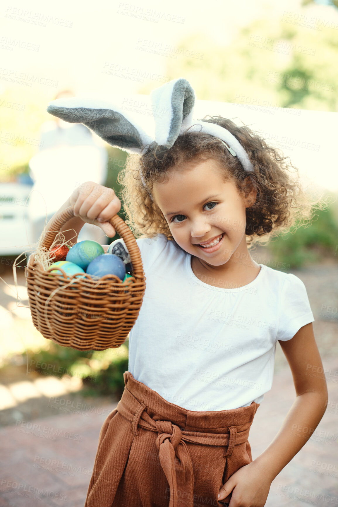 Buy stock photo Shot of a girl carrying a basket of easter eggs