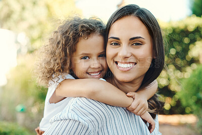 Buy stock photo Shot of a young woman giving her daughter a piggyback ride