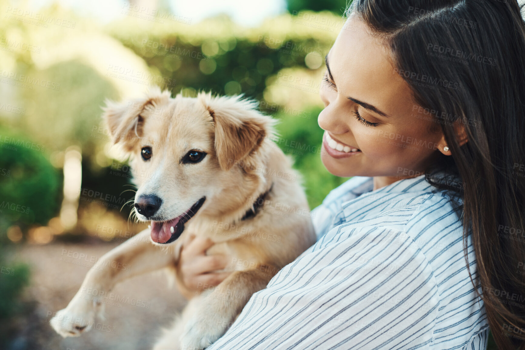 Buy stock photo Shot of a young woman cuddling her dog