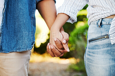 Buy stock photo Cropped shot of an affectionate unrecognizable couple walking hand in hand in their yard at home