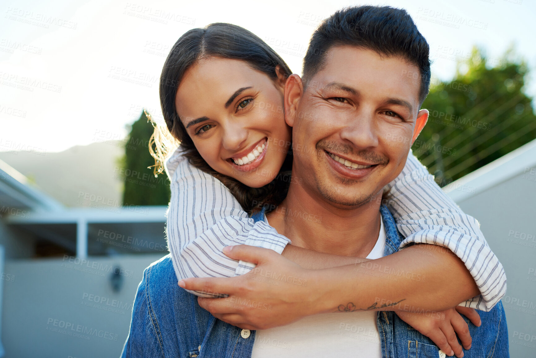 Buy stock photo Cropped portrait of an affectionate young couple chilling outside in their yard at home