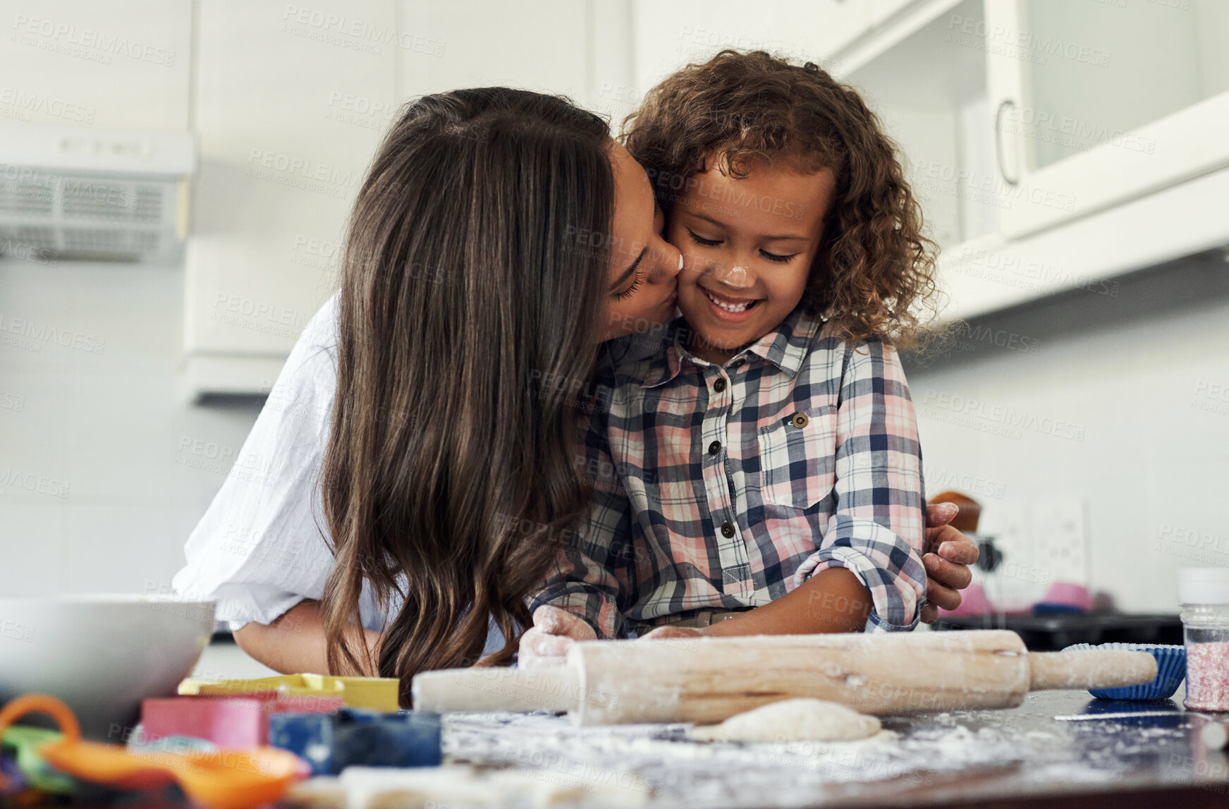 Buy stock photo Mom, kid and baking with kiss by table in kitchen for pastry recipe, support and teaching at home. Happy, woman and daughter with dough on rolling pin for ingredients, learning and love together