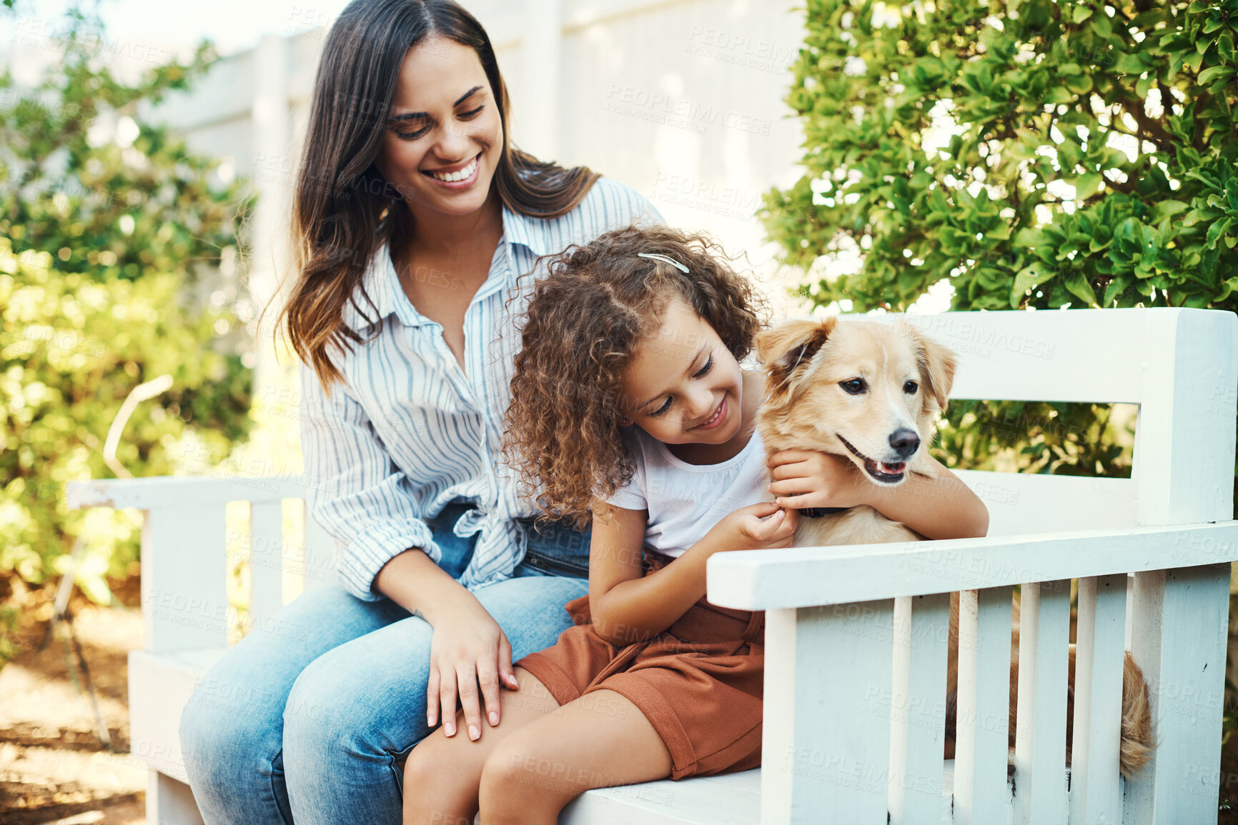 Buy stock photo Shot of a mother and daughter spending time together with their dog