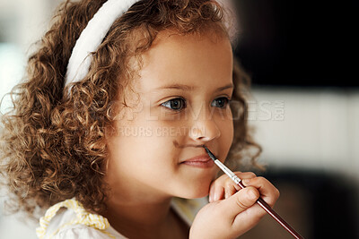 Buy stock photo Shot of a little girl painting her face to look like a bunny