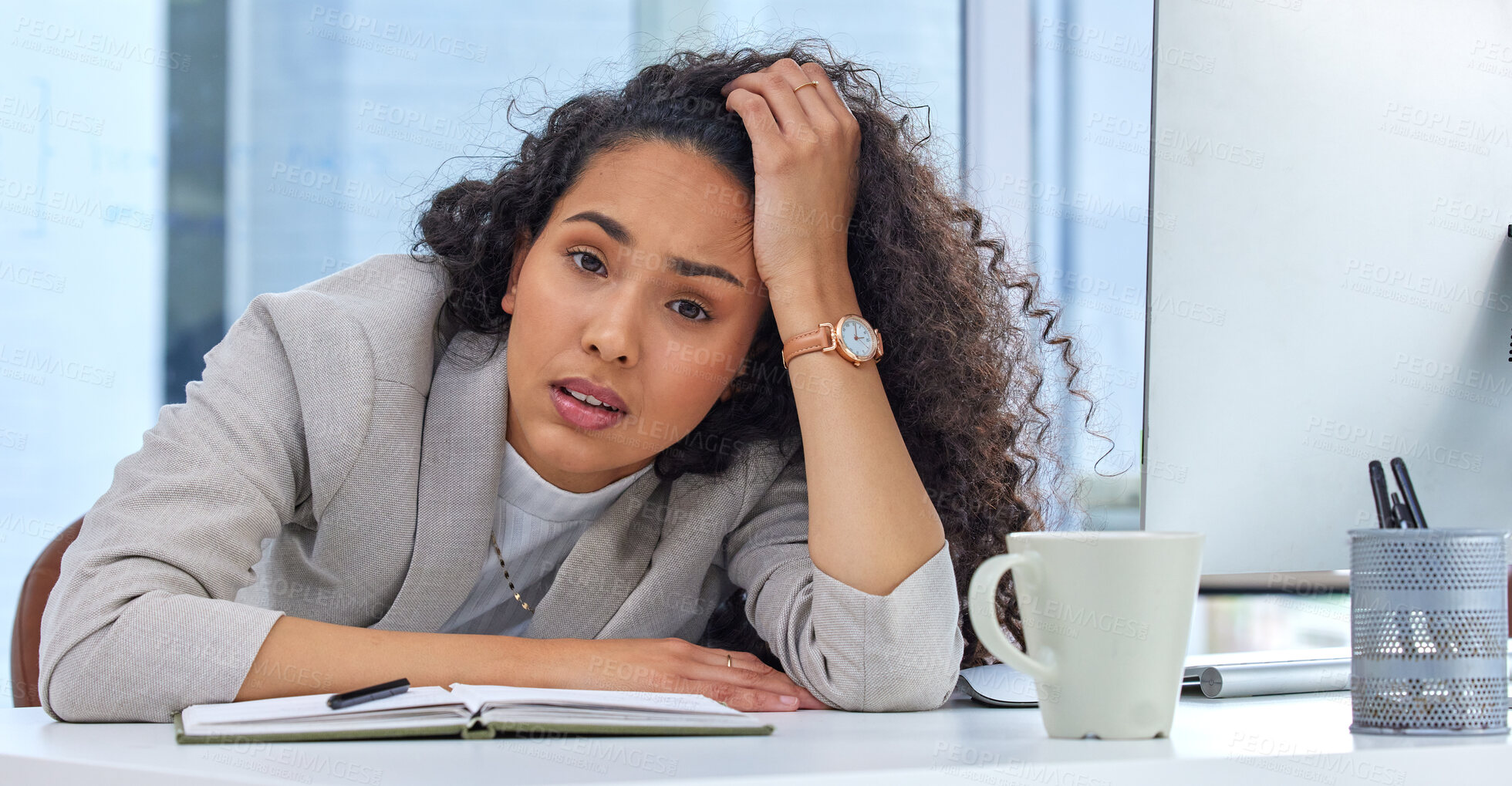 Buy stock photo Shot of a young businesswoman looking stressed out while working in an office