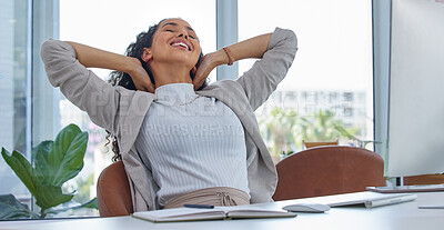 Buy stock photo Shot of a young businesswoman taking a break with her hands behind her head while working in an office