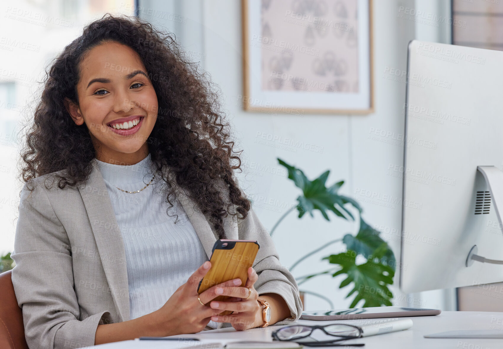 Buy stock photo Portrait of a young businesswoman using a cellphone in an office