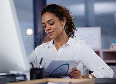 Buy stock photo Shot of a young businesswoman going through paperwork in an office at work