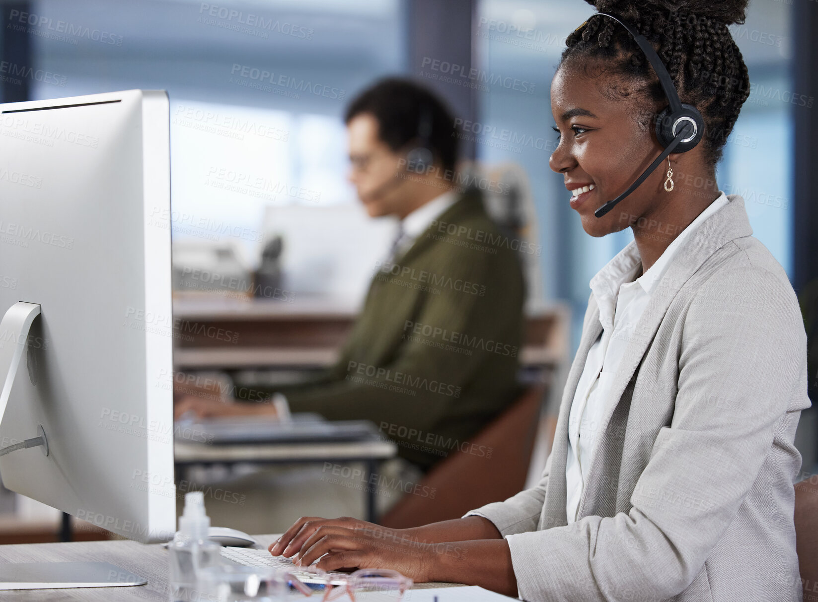 Buy stock photo Shot of two call center agents working in an office