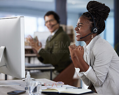 Buy stock photo Shot of a two colleagues celebrating success in an office at work