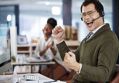 Buy stock photo Shot of a two colleagues celebrating success in an office at work