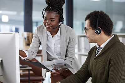 Buy stock photo Shot of two colleagues working together in an office at work